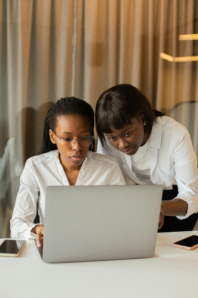 Two women working together at a laptop
