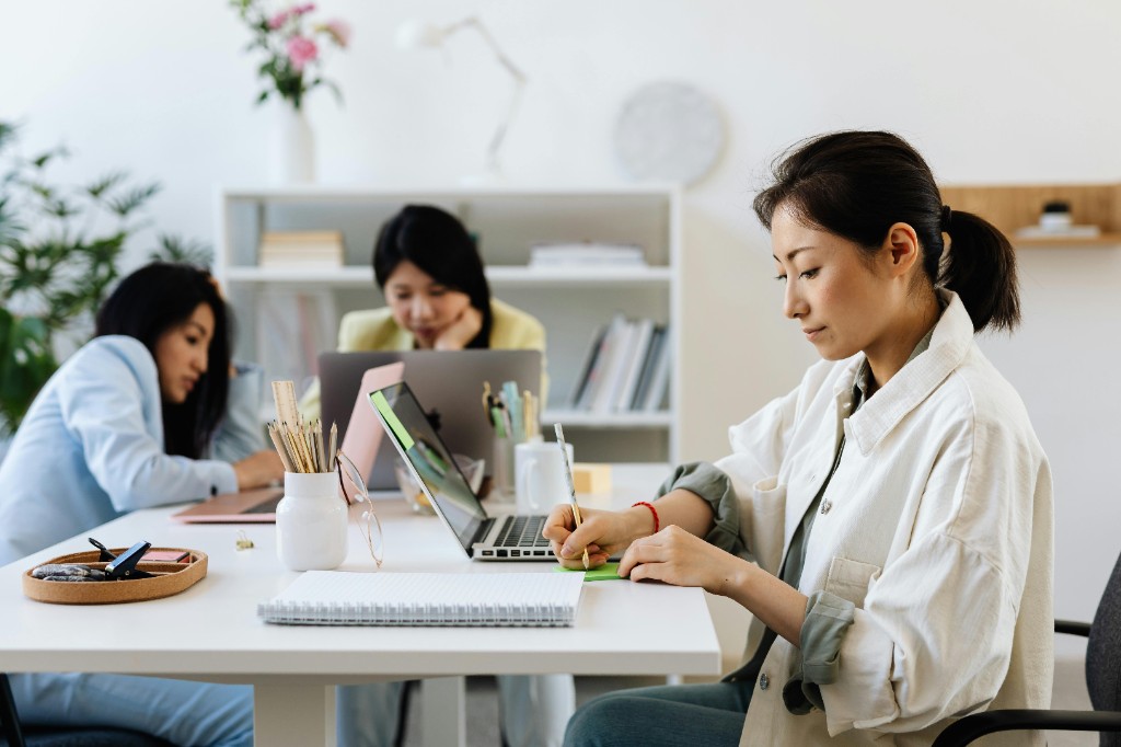 Women working together at a bright office desk
