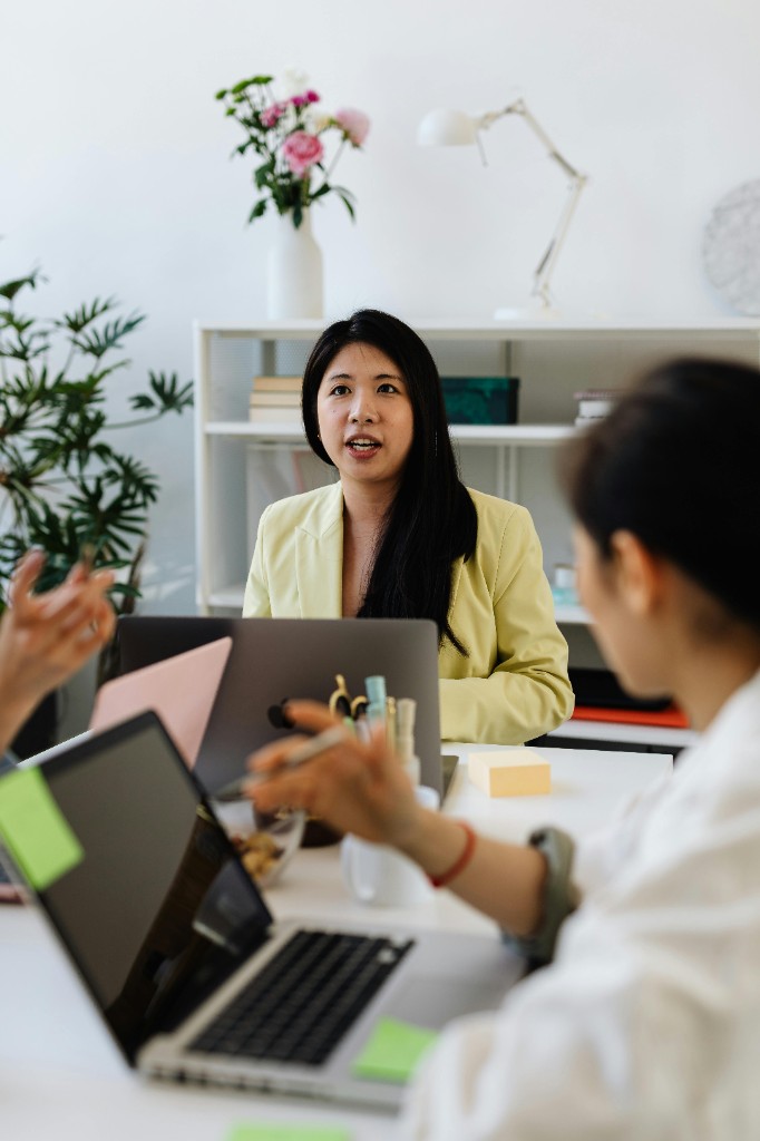 Women in a professional meeting, collaborating at a table